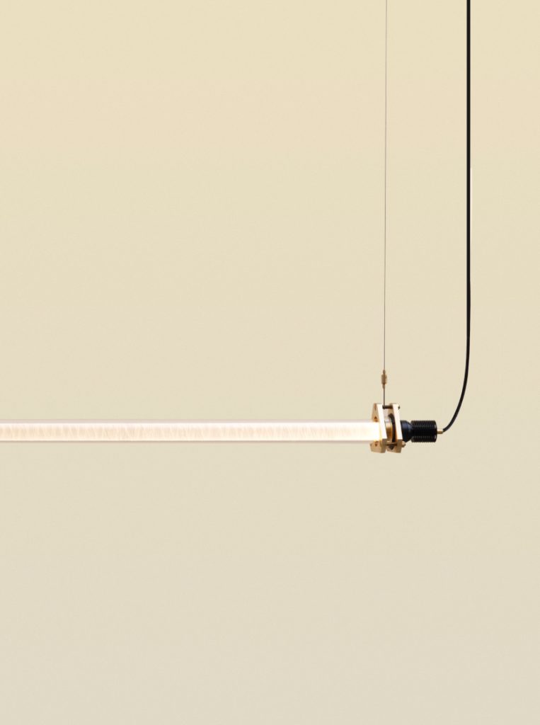 Suspended tube fixture: Brass and black cord elegance, a Nicolo Taliani creation that defines contemporary sophistication.