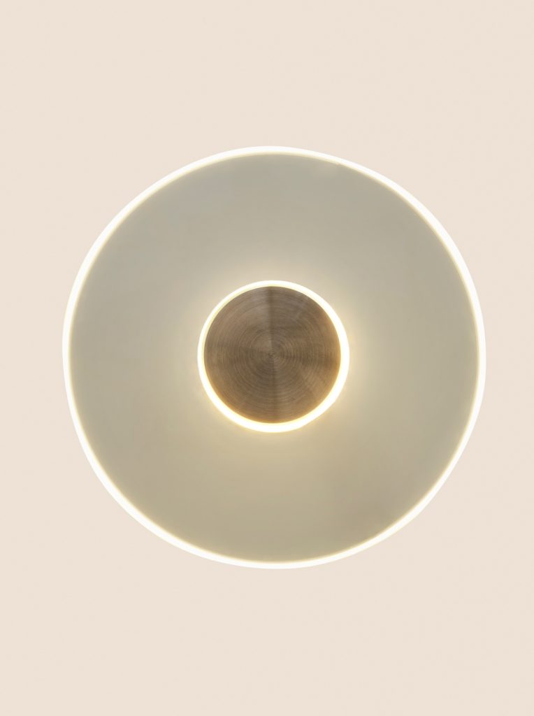 Circular glass wall light: Nicolo Taliani's minimalist fixture merges form and function seamlessly.