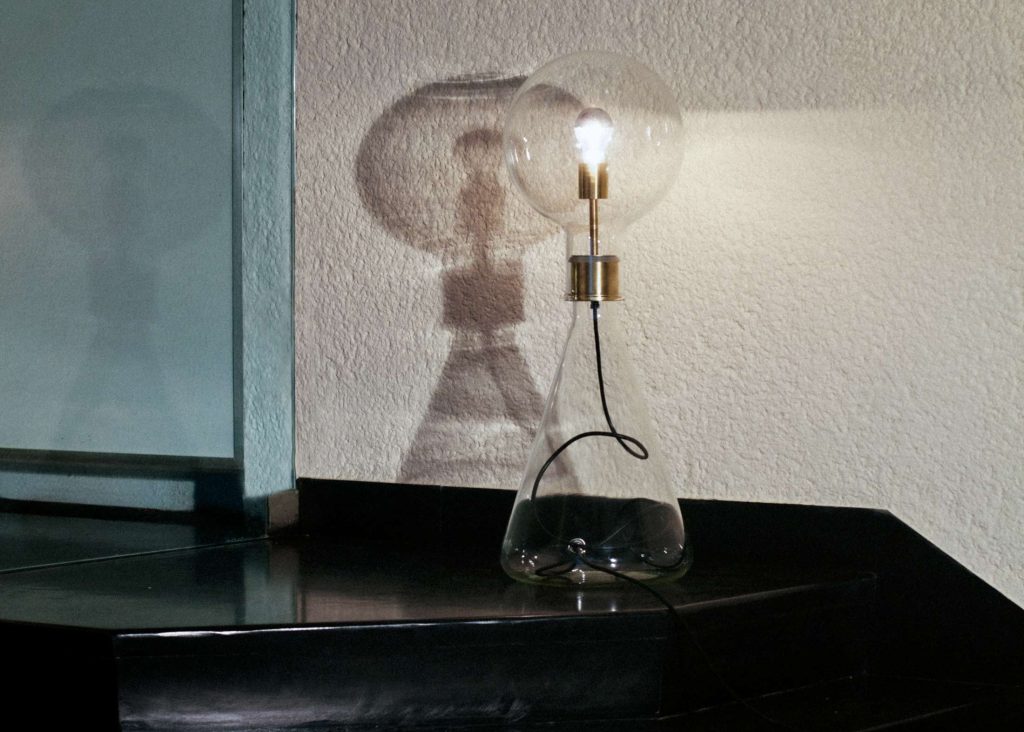 Glass & brass tall lamp: Nicolo Taliani's elegant illumination masterpiece for sophisticated spaces.